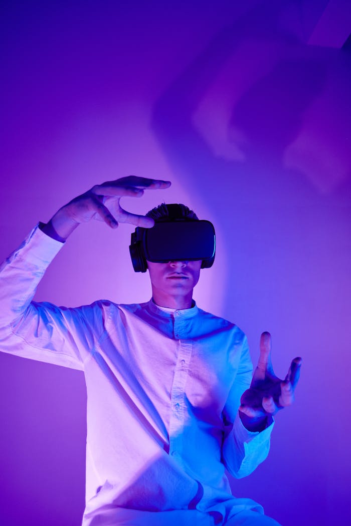 gallery-4 A man immersed in virtual reality wearing VR goggles in a modern studio setup.